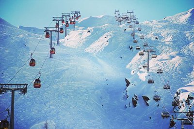 ski lifts ascending a glacier