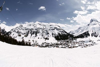 Ski piste leading down to village in valley