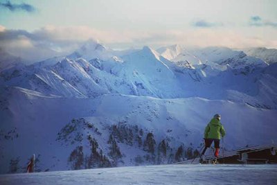 skier on a mountain at sunset