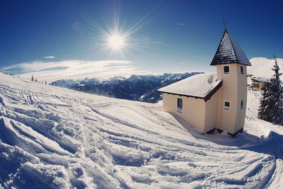 chapel in powder snow on a mountain top