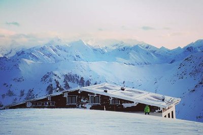 mountain hut covered in snow