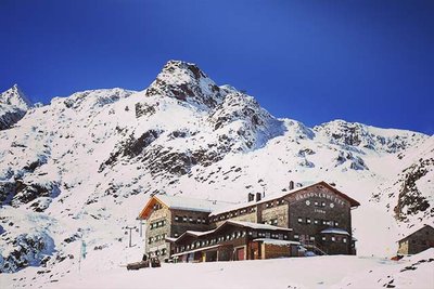 mountain hut covered in snow